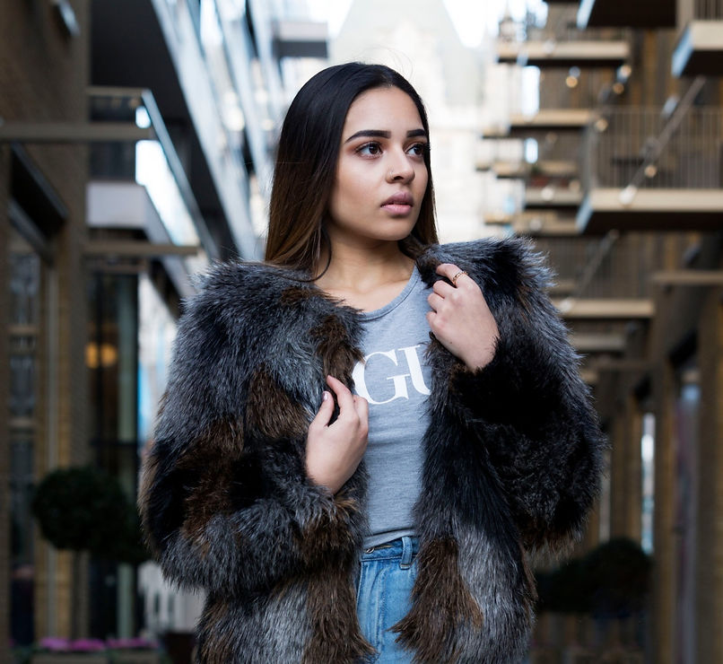 Portrait photographer took picture of model in fur coat posing in the city of London