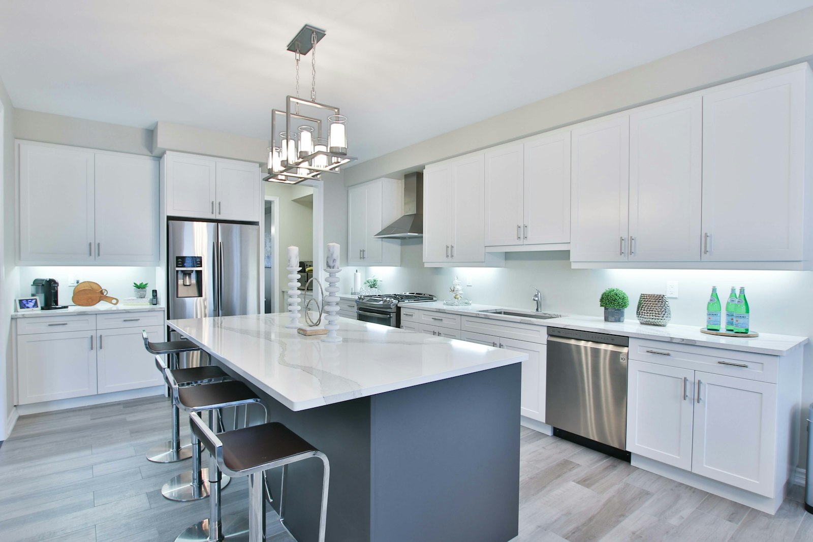 Kitchen with painted white cabinets and a contrasting dark island