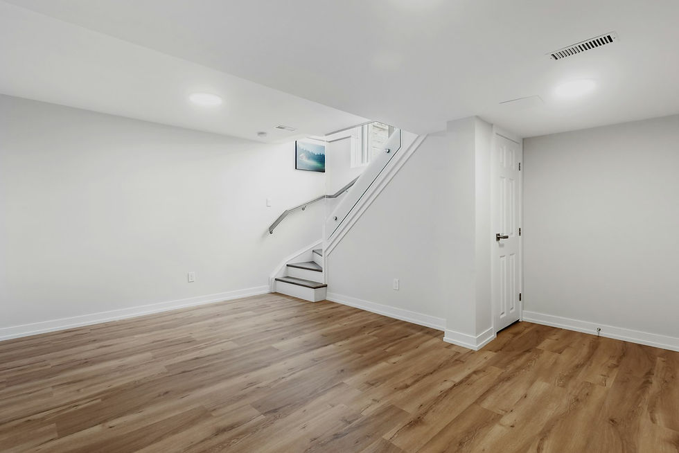 Finished basement with wood-look flooring and staircase
