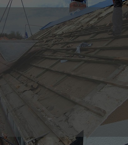 builder-removing-old-roof-tiles-from-an-