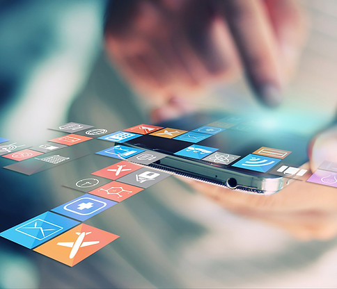 Close-up of a person using their phone, their menu of apps expanding out of the borders of the screen
