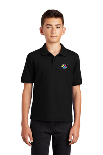 Boy in a black polo shirt showcasing a subtle embroidered heart design on the front