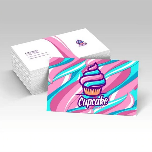 A white stack of silk business cards next to a single card featuring a cupcake design and the text 'Cupcake'.