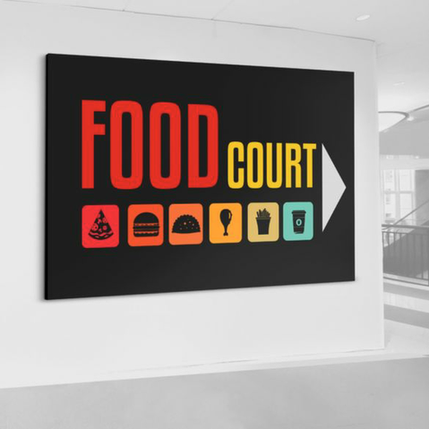 Large wall graphic in a gallery setting reading “FOOD COURT” with food icons underneath.