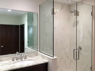 Professional residential glass replacement showcasing a frameless shower enclosure, custom vanity mirrors for homes in Collin County.