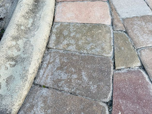 Pavers in Cape Coral showing fading, water absorption, and joint sand loss as signs it’s time for professional paver resealing.