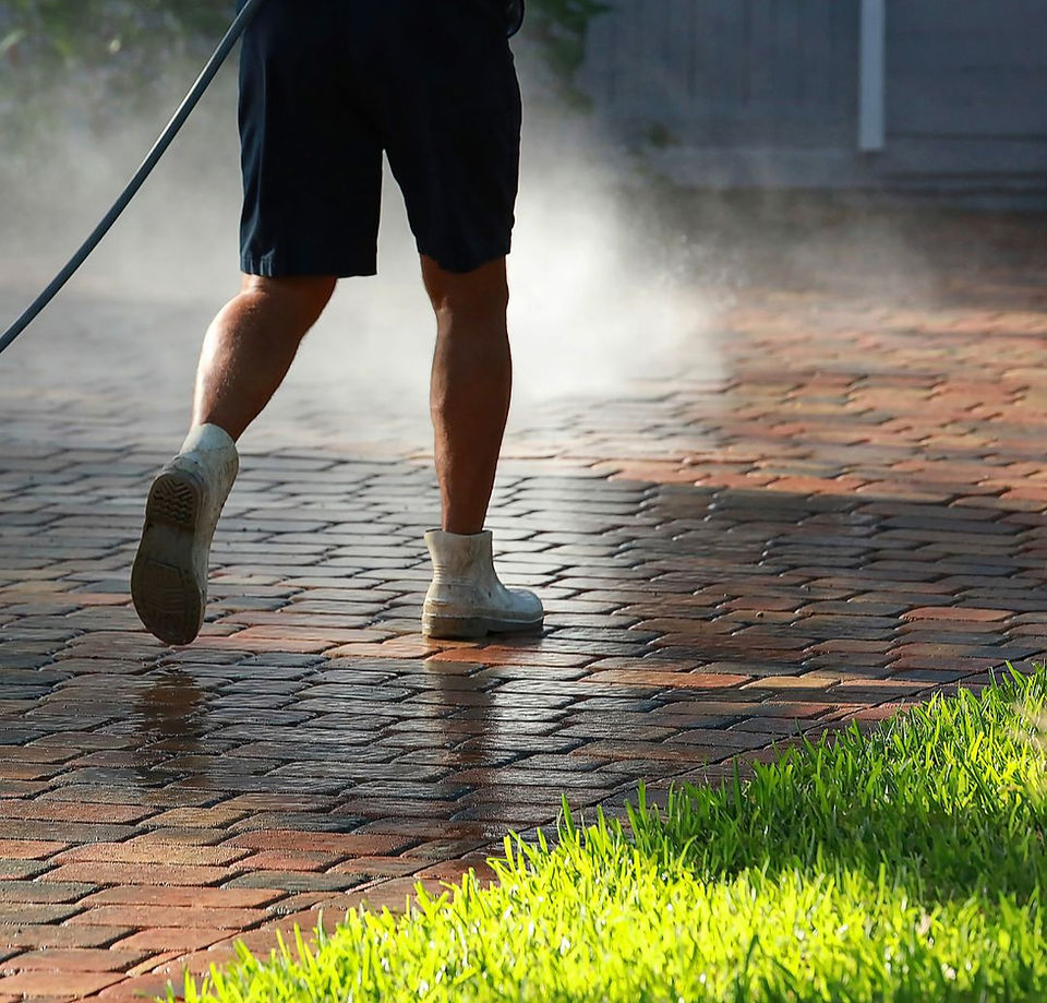 Expert paver sealing application creating a glossy, long-lasting protective coating on freshly clean