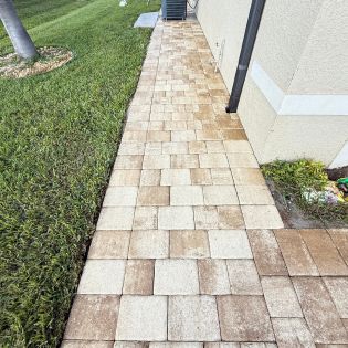 Pressure washing Cape Coral sidewalk cleaning mildew before seasonal residents arrive