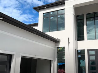 Professional pressure washing removes concrete dust and debris from new home exterior in Fort Myers