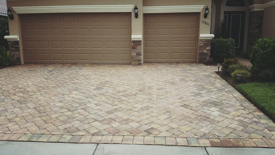 Driveway paver cleaning in progress in Cape Coral.