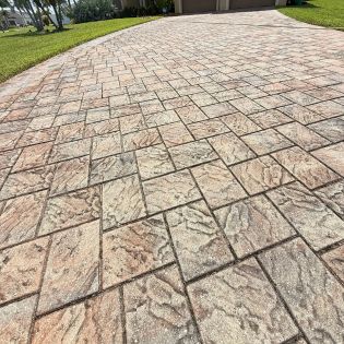 Dull and dirty paver driveway in Cape Coral before professional cleaning and sealing, showing faded color and surface buildup.