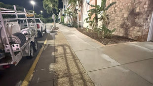 AAA Pressure Washing team performing after-hours commercial pressure washing at a Cape Coral strip mall, leaving storefront walkways bright and clean before morning business hours.