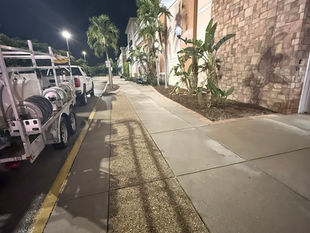 AAA Pressure Washing team performing after-hours commercial pressure washing at a Cape Coral strip mall, leaving storefront walkways bright and clean before morning business hours.