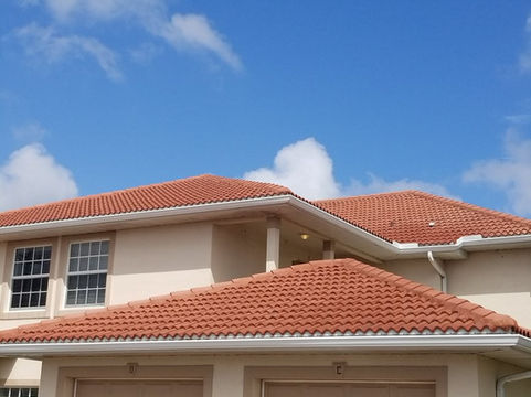 Tile roof cleaning process in Cape Coral, showing visible results of dirt removal.