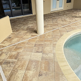Pool deck paver sealing in Cape Coral showing restored color, protected joints, and a clean finished surface.