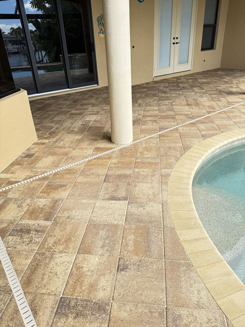 After photo of a sealed pool deck in Cape Coral with restored color and a clean, protected surface following professional paver sealing.
