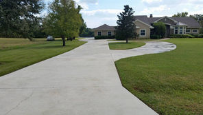 Long concrete driveway in Cape Coral, fully restored after pressure washing services.