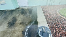 Rear parking lot transformation with mildew and grime removed to reveal bright, clean concrete surface.