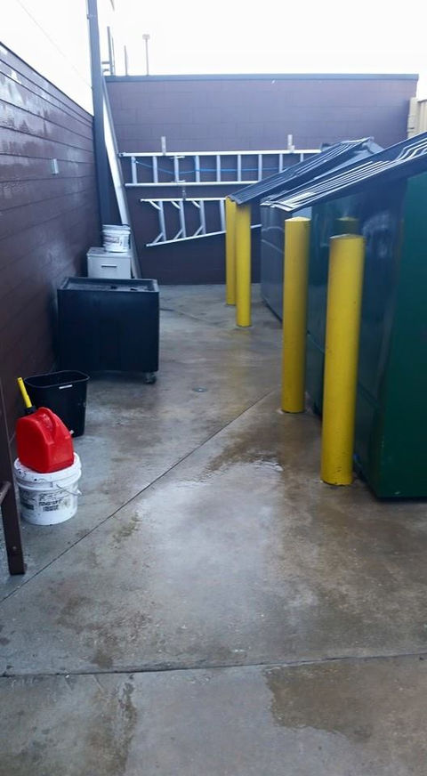 Restaurant dumpster area in Cape Coral being cleaned with professional commercial pressure washing services for improved sanitation.