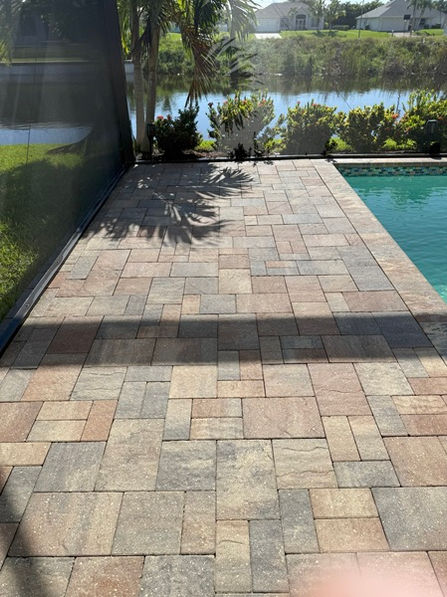 After image of a paver pool deck in Cape Coral showing clean, bright pavers following professional pressure washing.