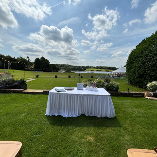 Wedding ceremony table on grass with views overlooking a lake