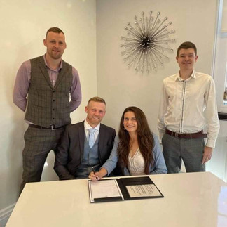 Legal Statutory Ceremony with 2 Witnesses, bride and groom sat down signing.