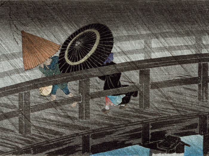 Traditional Japanese woodblock print of figures crossing a bridge in the rain
