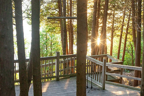 Outdoor chapel. The sunset pokes through the cedar trees. 