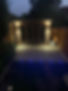 A garden at night showing the lights in the decking.