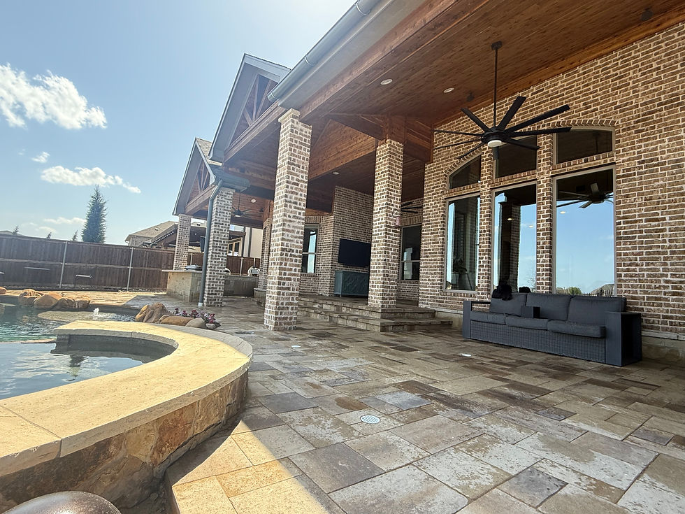 Elegant outdoor patio with ample seating, ceiling fan, and a view of a sparkling pool against a blue sky, perfect for relaxation and entertaining.