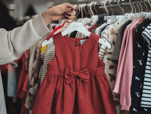 Parents checking soft and comfortable kidswear before buying for their child