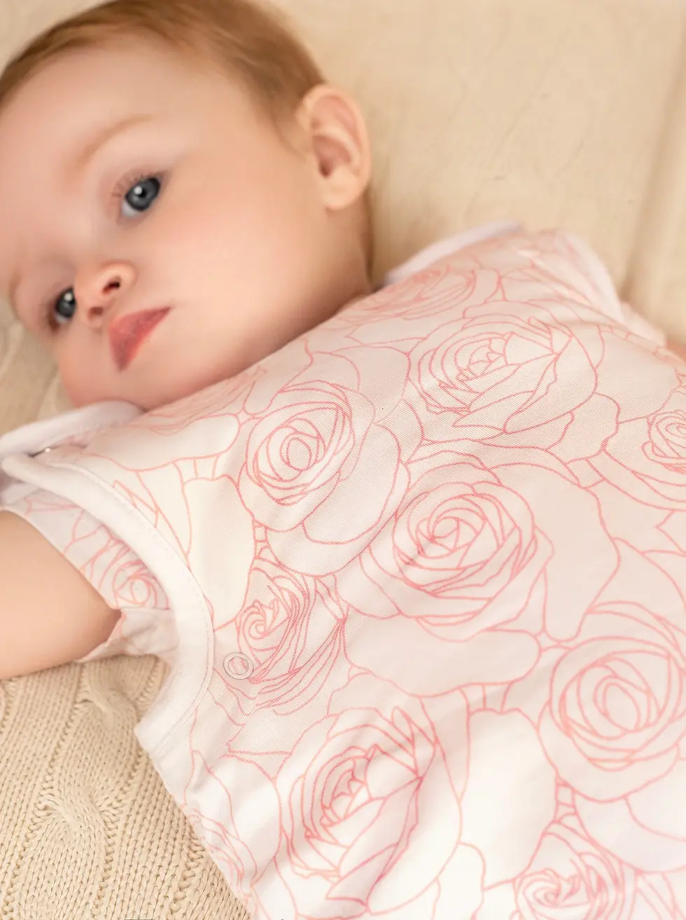 Close-up of baby wearing BambooBaby PinkRose bamboo sleeping bag, highlighting soft fabric and floral print