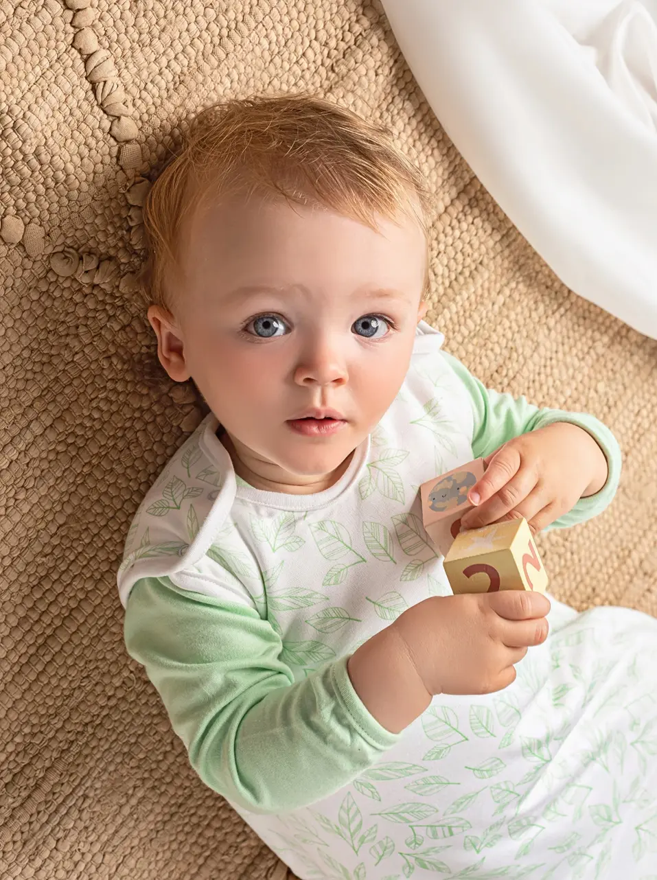 Close-up of baby resting in BambooBaby GreenLeaf bamboo sleeping bag, highlighting soft fabric and fit
