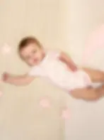 Baby wearing BambooBaby PinkRose bamboo bodysuit, showing comfortable fit and soft fabric on skin