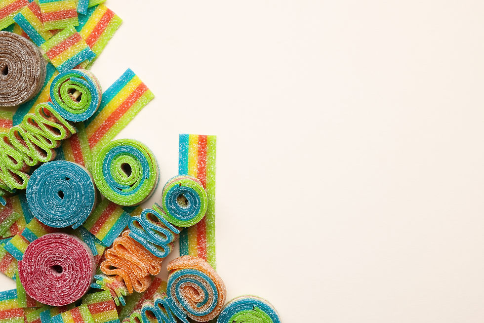 Different tasty sour belts on beige background, top view Space for text.jpg