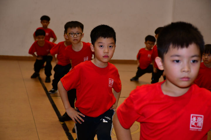 Young students taking a bow stance.