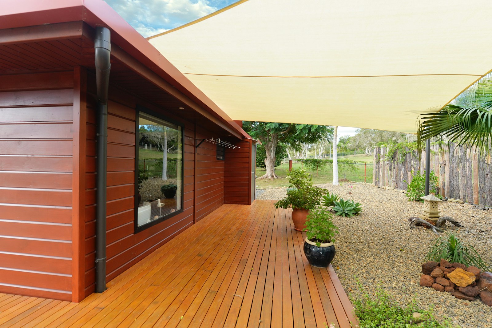 Wooden house with a deck and a gravel garden
