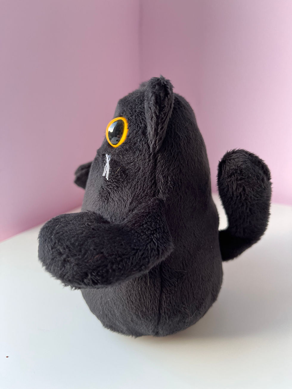 Thumbnail: Black cat plush toy side view