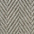 Close-up of a woven rug with a herringbone pattern in beige and dark gray.