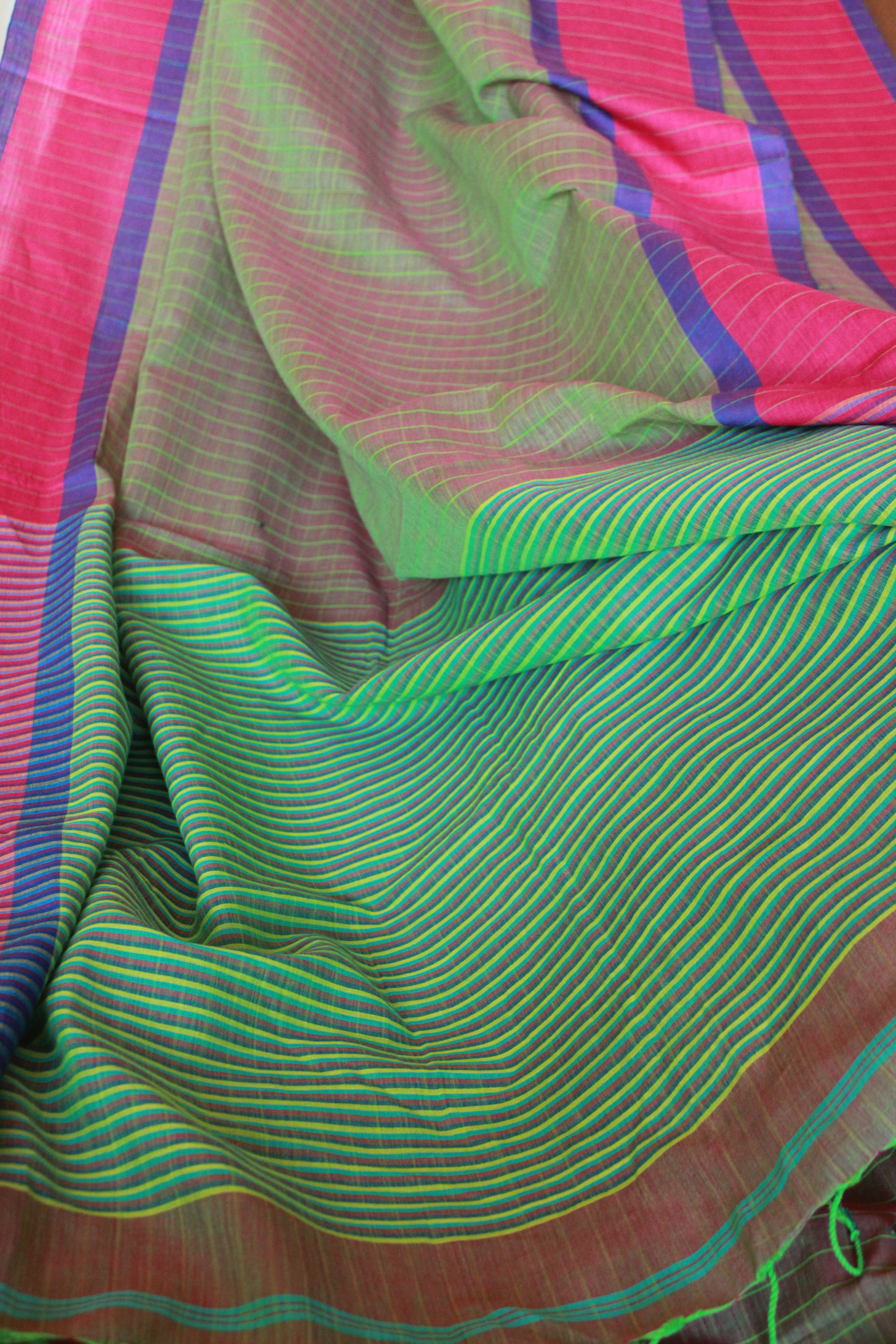 Bengal cotton saree in a subtle shade of green with bright pink border
