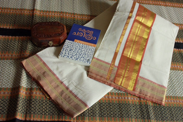 Thumbnail: A handwoven kasavu saree with pure zari on a burnt orange border