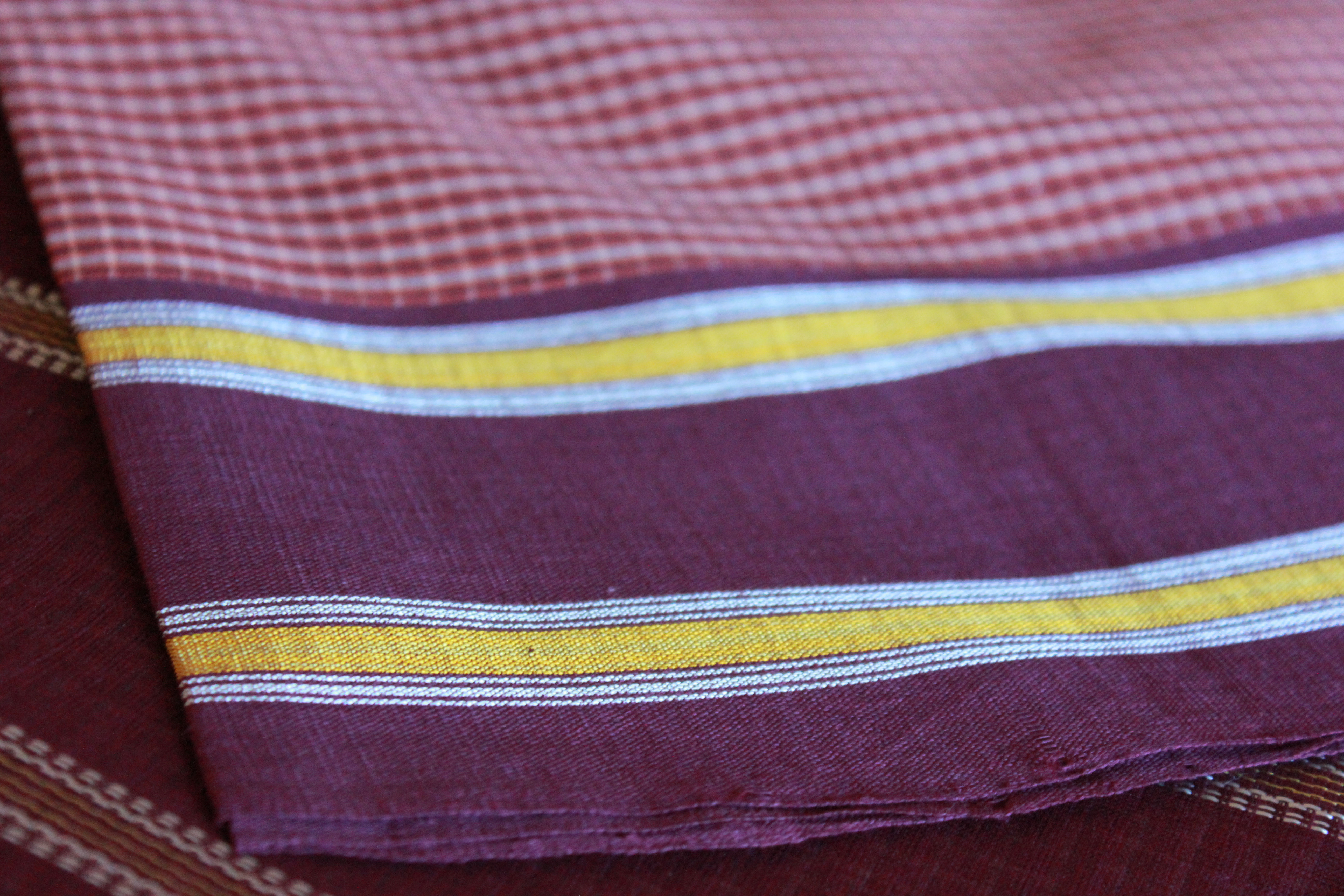 A checkered udupi handloom cotton saree with a maroonish -sangria border