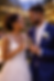 African-American bride and groom toasting with champagne at an outdoor twilight reception under string lights after a luxury wedding planned by a Denver wedding planner.