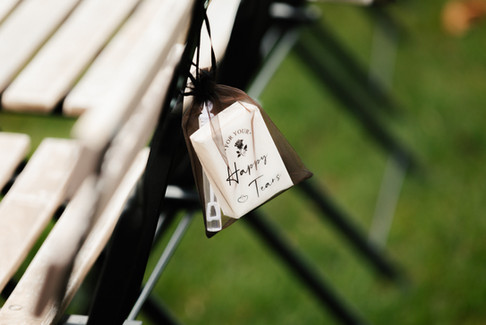 Personalized Happy Tears tissues displayed on ceremony chairs for wedding guests at The Oaks at Plum Creek.