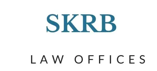 Blue text "SKRB" above black text "LAW OFFICES" on white background. Simple and professional design, conveying legal services brand.