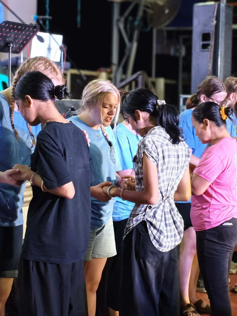 Judah Christian School students praying over Filipino women