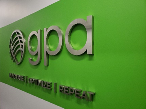 GPA logo mounted on a bright green wall with the words ‘GPA’ and the tagline ‘Observe | Optimize | Repeat’ displayed in metallic lettering.