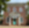 Two-story brick building with white columns and a teal front door, featuring a GPA sign above the entrance.