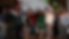 Group of GPA employees standing together at a holiday-themed event in front of a branded GPA backdrop with festive decorations, including balloons and ornaments.