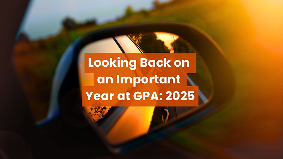 A car’s side mirror reflecting a road at sunset, overlaid with the text “Looking Back on an Important Year at GPA: 2025” in bold orange and white lettering.